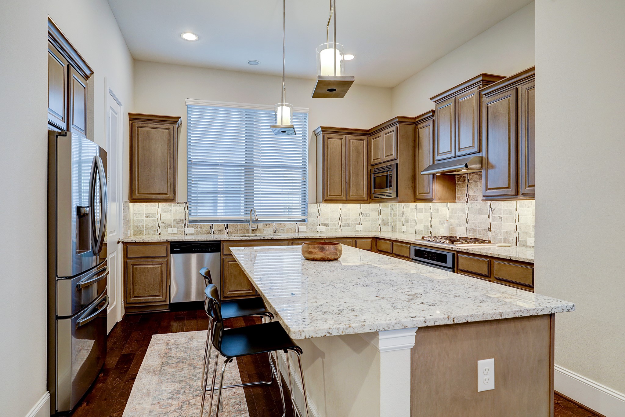 5453 Larkin Street Houston, TX 77007 - Photo 12 of 38 a kitchen with granite countertop kitchen island stainless steel appliances a sink stove and refrigerator
