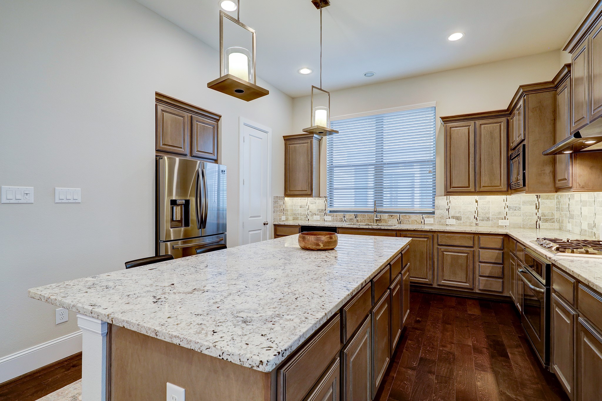 5453 Larkin Street Houston, TX 77007 - Photo 13 of 38 a kitchen with stainless steel appliances granite countertop a sink a stove and a wooden floors