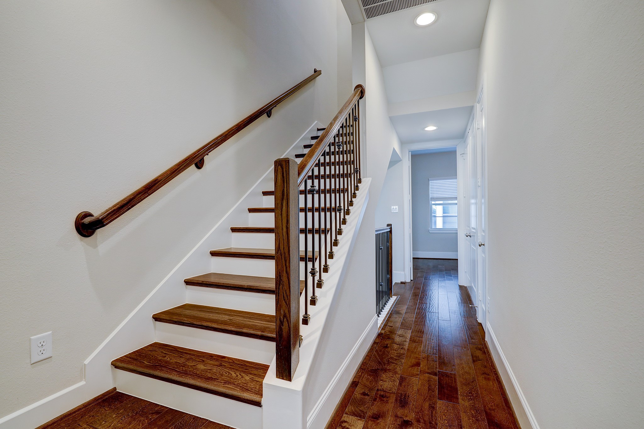 5453 Larkin Street Houston, TX 77007 - Photo 20 of 38 a view of a hallway with wooden floor and staircase