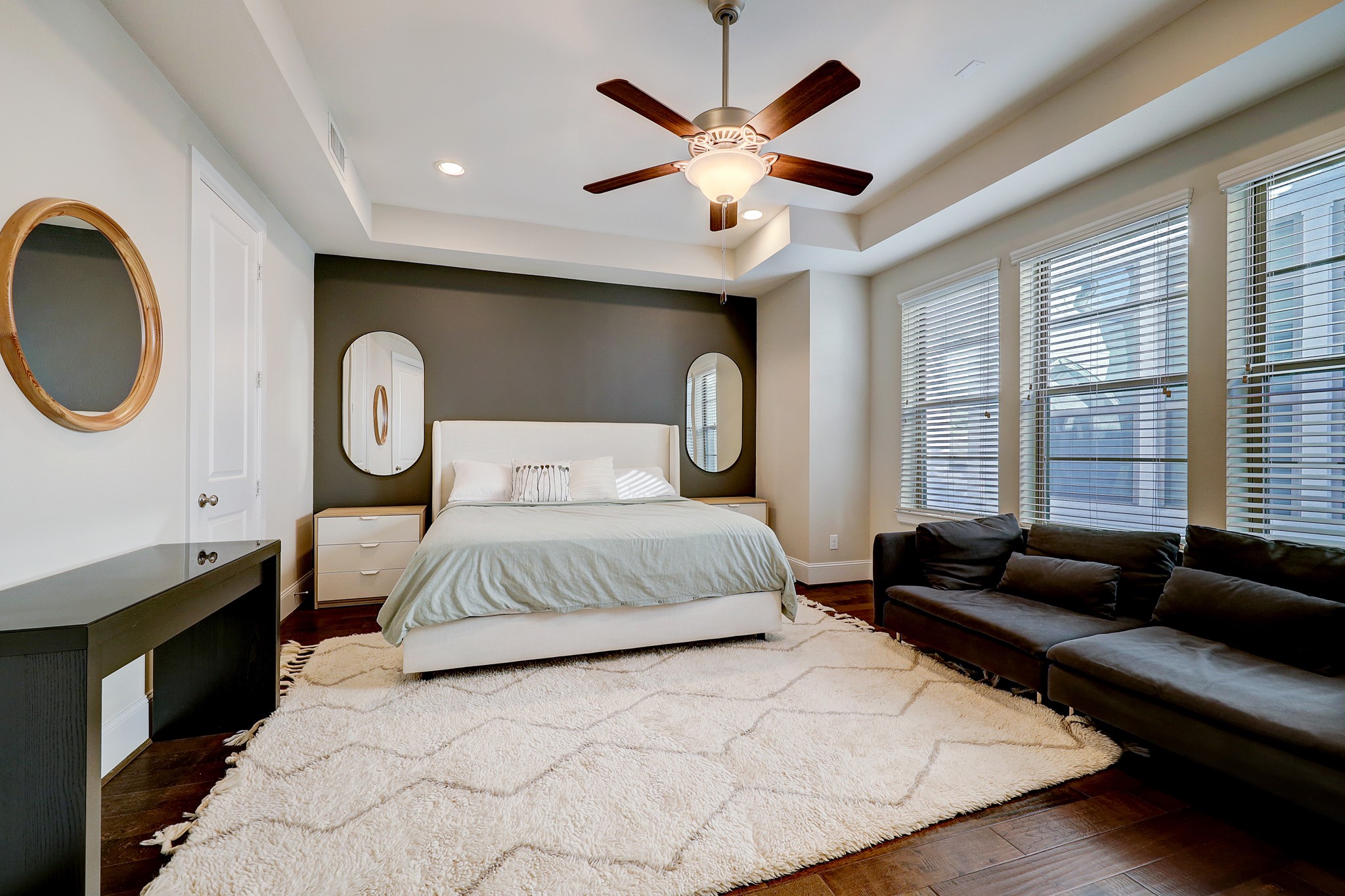 5453 Larkin Street Houston, TX 77007 - Photo 21 of 38 a bedroom with a large bed and a chandelier