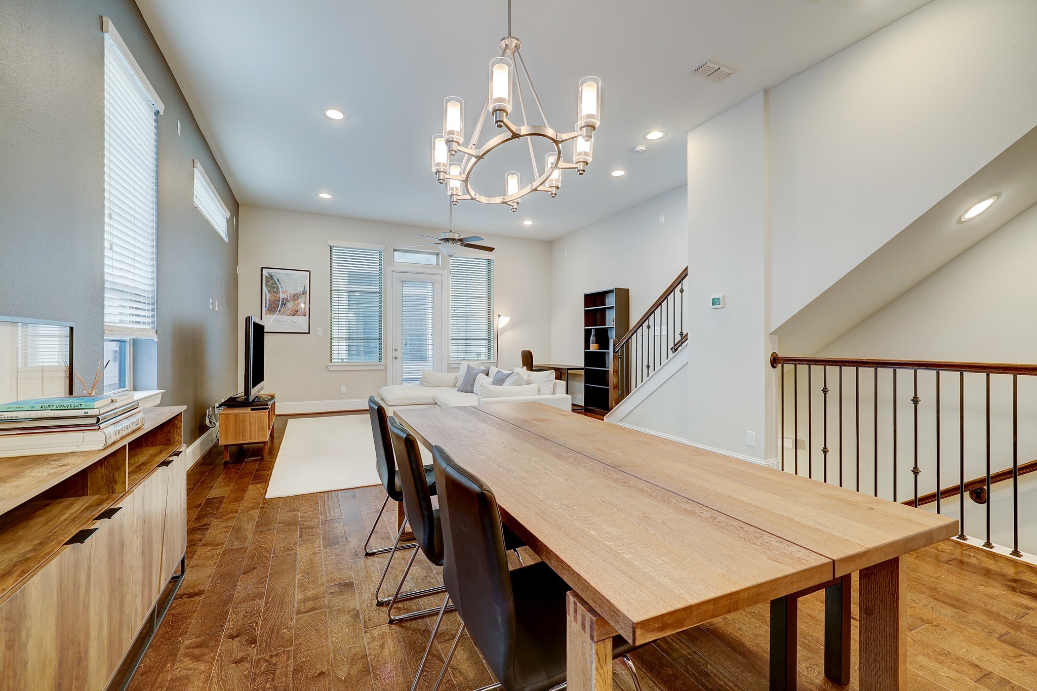 5453 Larkin Street Houston, TX 77007 - Photo 10 of 38 a dining room with wooden floor a chandelier a wooden table and chairs