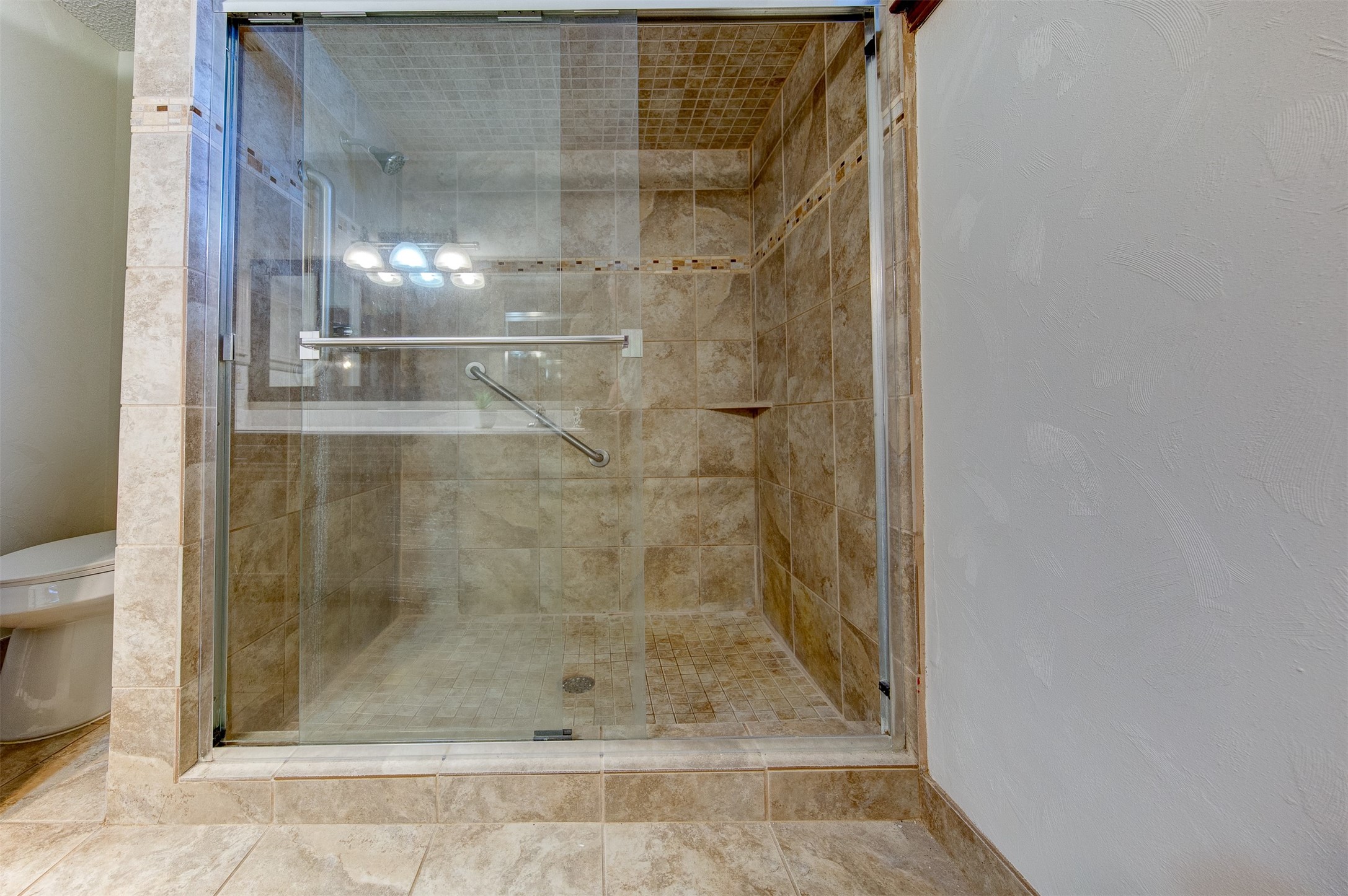 15802 Mill Point Drive Houston, TX 77059 - Photo 17 of 23 a bathroom with a glass shower door