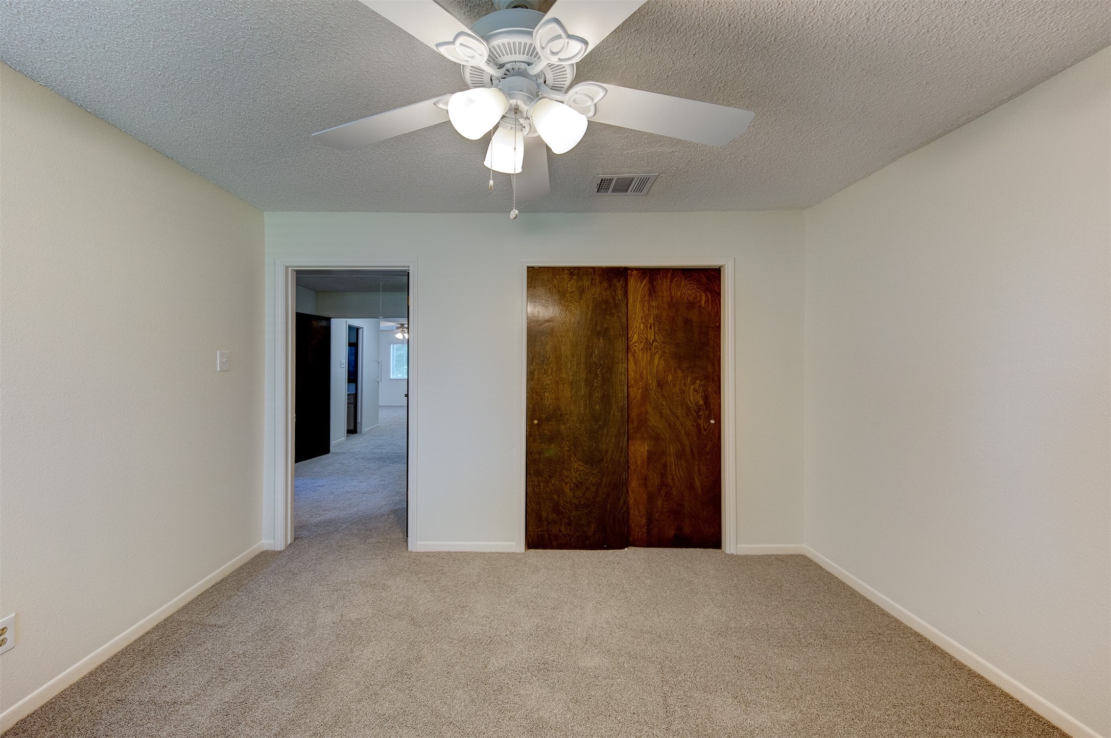15802 Mill Point Drive Houston, TX 77059 - Photo 20 of 23 a view of an empty room with a chandelier fan