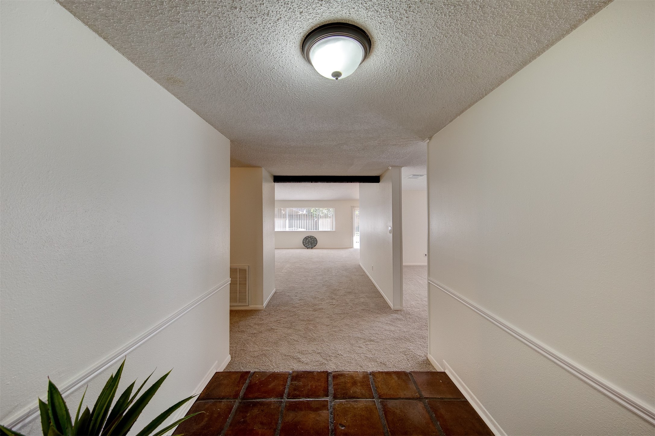 15802 Mill Point Drive Houston, TX 77059 - Photo 4 of 23 a view of a hallway to room with wooden floor