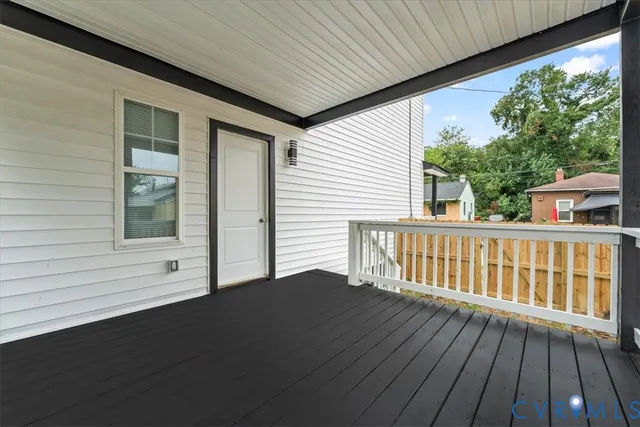 a view of balcony with wooden floor
