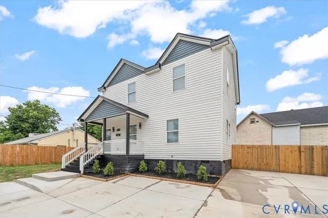 a view of a house with wooden fence