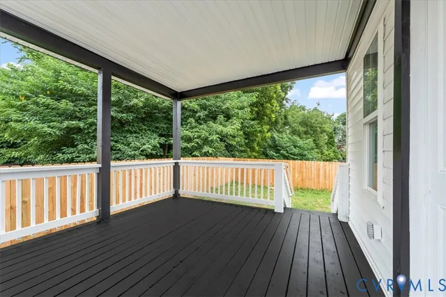 a front view of house with deck and yard