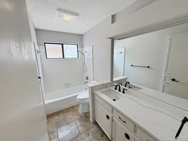 a bathroom with a double vanity sink mirror and toilet