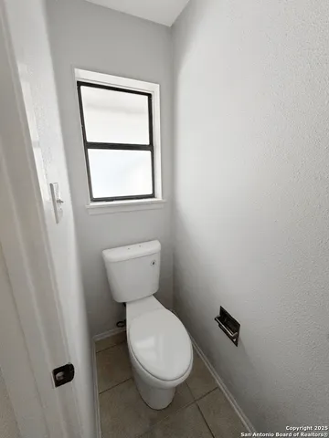 a white toilet sitting next to a window