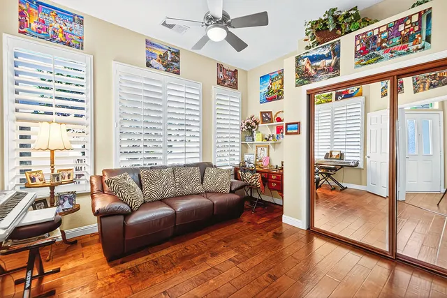 a bedroom with a bed next to a window