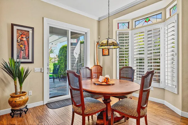 a view of a dining room with furniture window and wooden floor