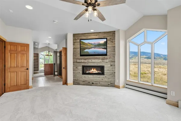 a view of an empty room with a fireplace and a window