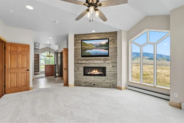 a view of an empty room with a fireplace and a window