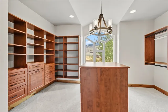 a view of an empty room with cabinet and a window