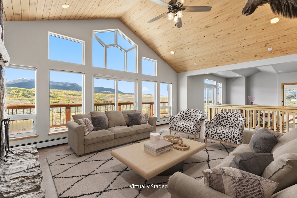 845 Elk Run Road Silverthorne, CO 80498 - Photo 3 of 50 a living room with furniture ceiling fan and a rug