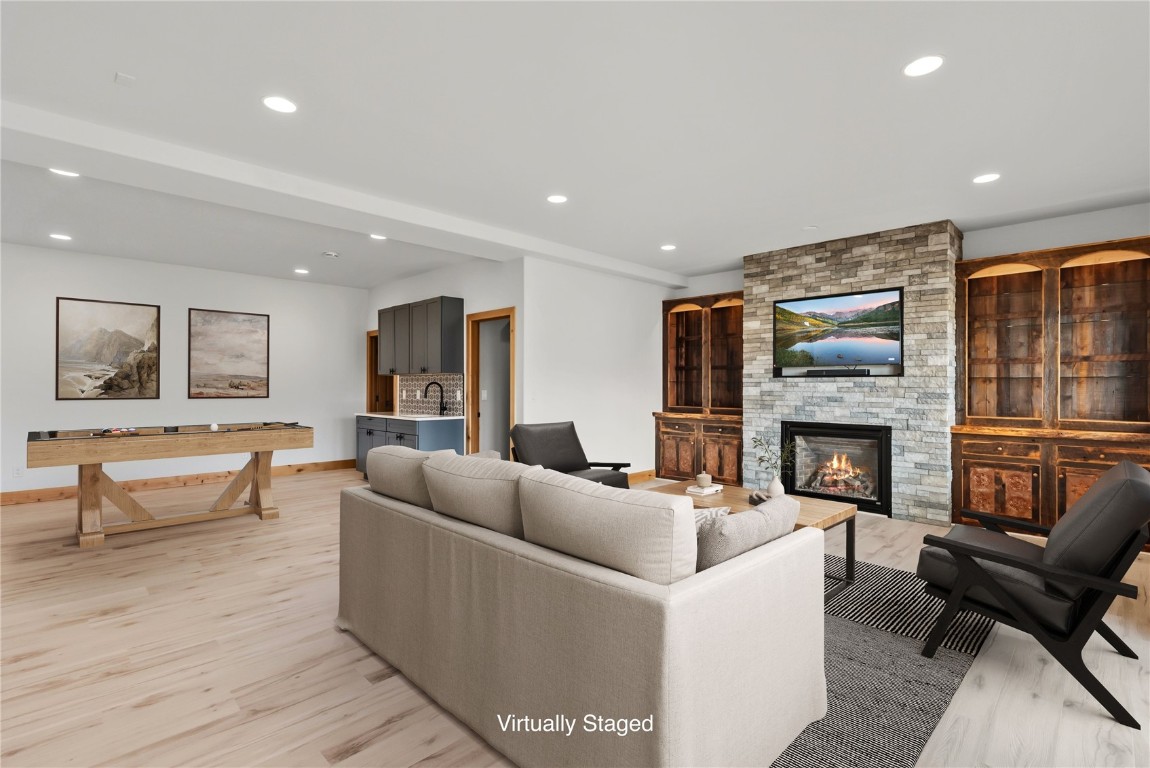 845 Elk Run Road Silverthorne, CO 80498 - Photo 32 of 50 a living room with furniture and a fireplace