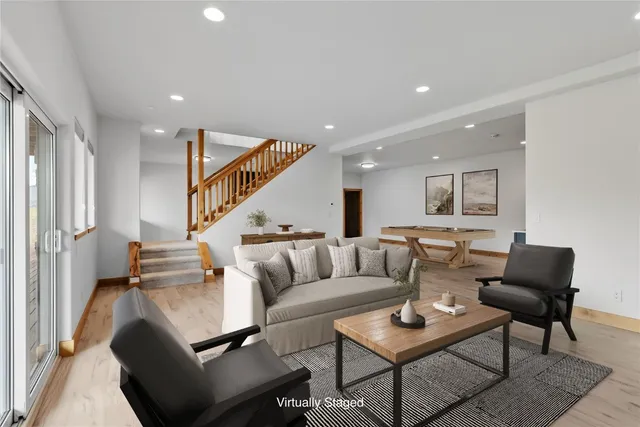 a view of an entryway with wooden floor