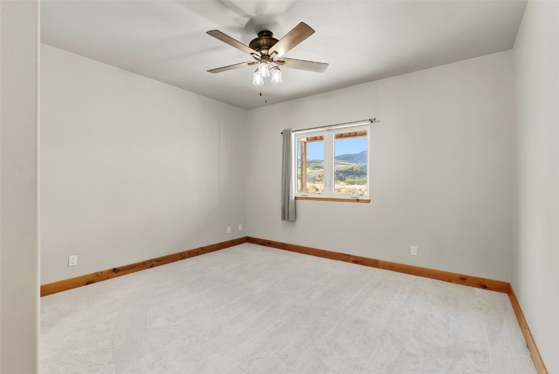 845 Elk Run Road Silverthorne, CO 80498 - Photo 43 of 50 an empty room with a window and a ceiling fan