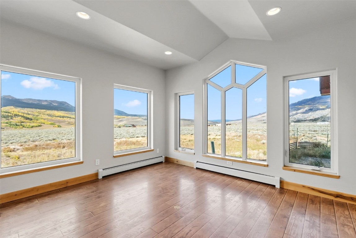 845 Elk Run Road Silverthorne, CO 80498 - Photo 10 of 50 a view of an empty room with wooden floor and doors