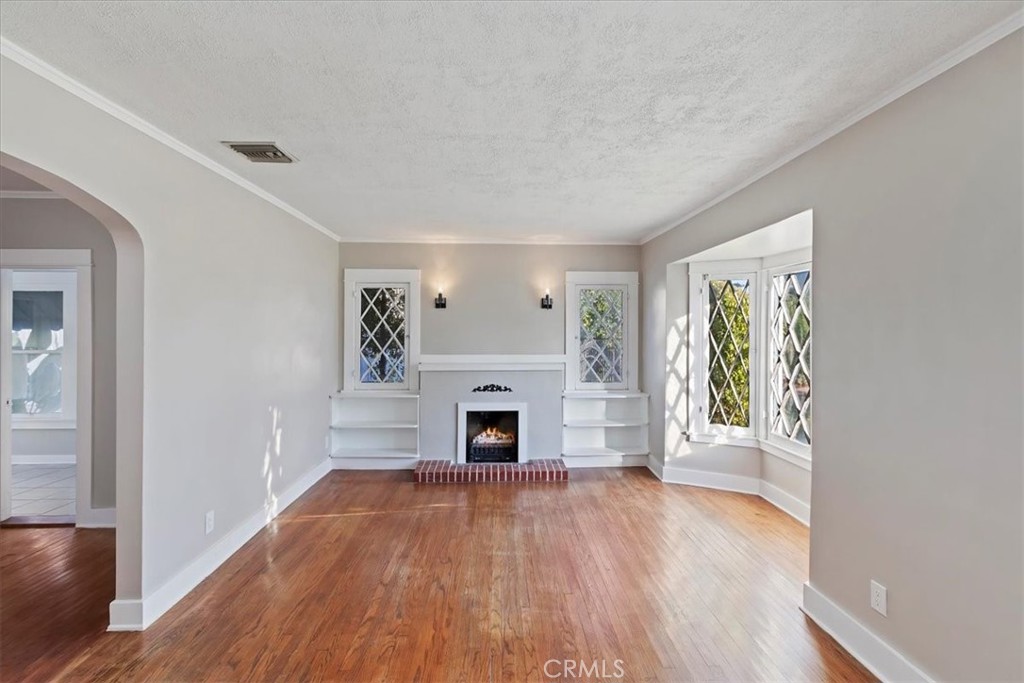 4311 Sunnyside Drive Riverside, CA 92506 - Photo 11 of 40 wooden floor fireplace and windows in an empty room