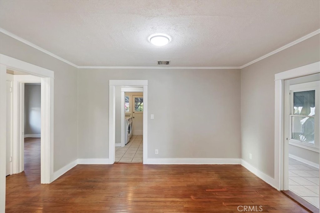4311 Sunnyside Drive Riverside, CA 92506 - Photo 13 of 40 a view of an empty room with wooden floor and a window