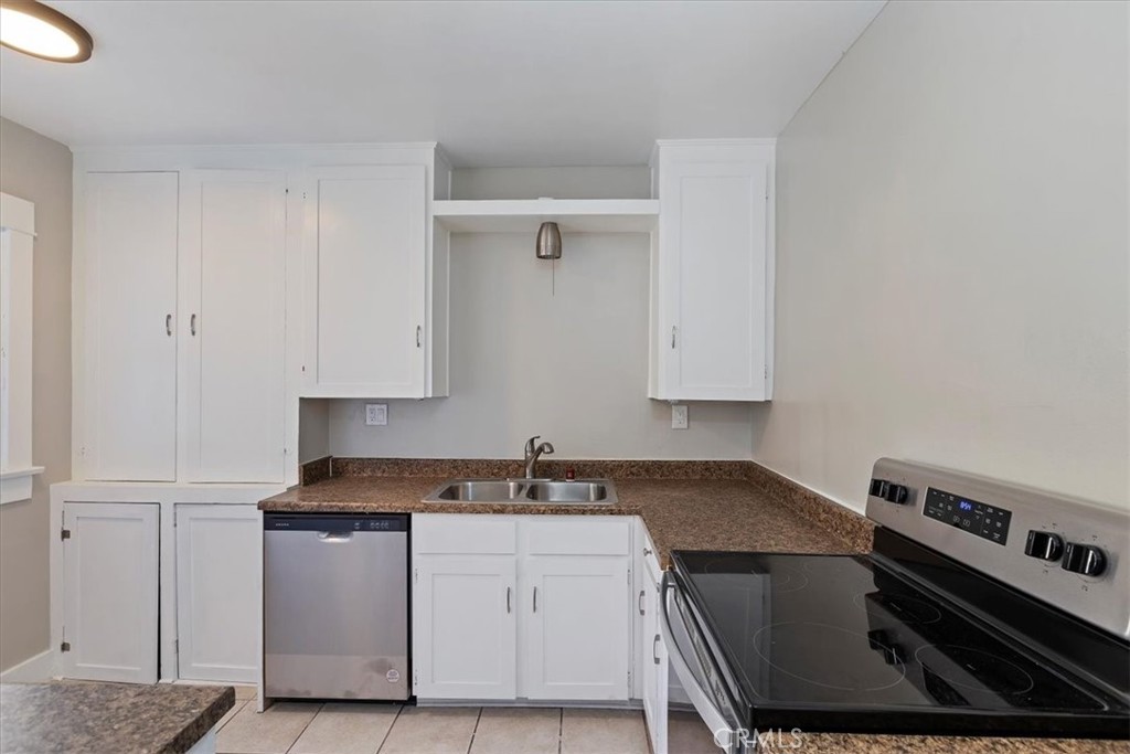 4311 Sunnyside Drive Riverside, CA 92506 - Photo 18 of 40 a kitchen with a stove and white cabinets