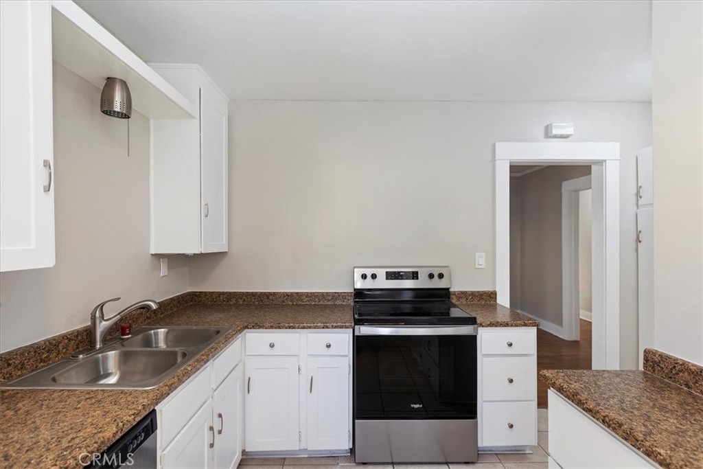 4311 Sunnyside Drive Riverside, CA 92506 - Photo 19 of 40 a kitchen with granite countertop a stove and a sink