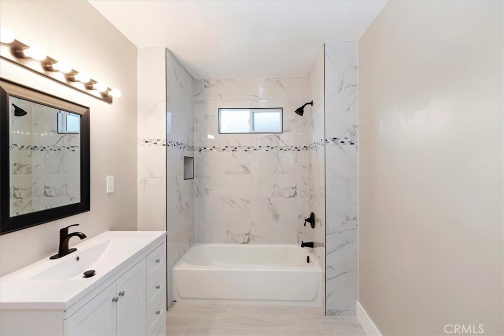 4311 Sunnyside Drive Riverside, CA 92506 - Photo 25 of 40 a bathroom with a bathtub a shower a sink and mirror