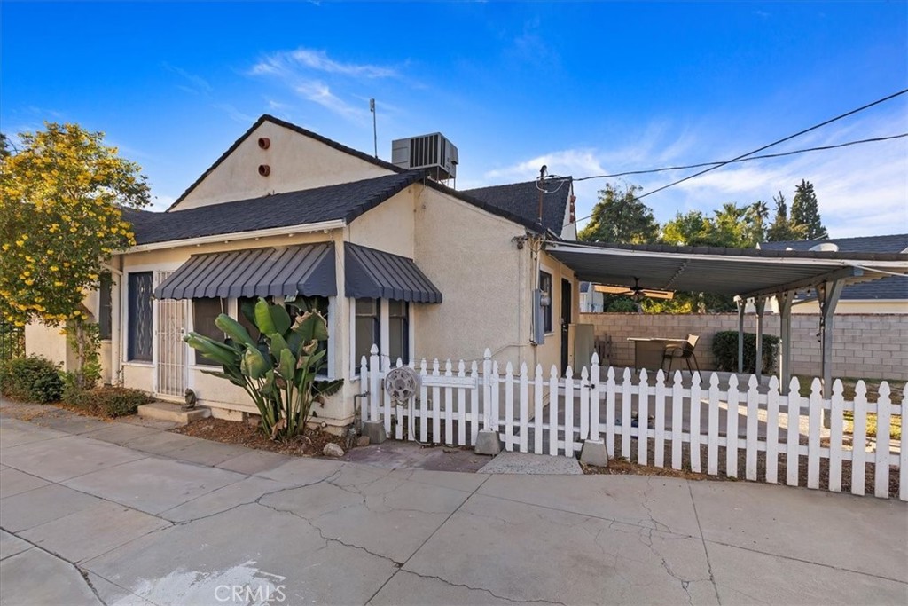 4311 Sunnyside Drive Riverside, CA 92506 - Photo 31 of 40 a front view of a house with glass windows and a fence