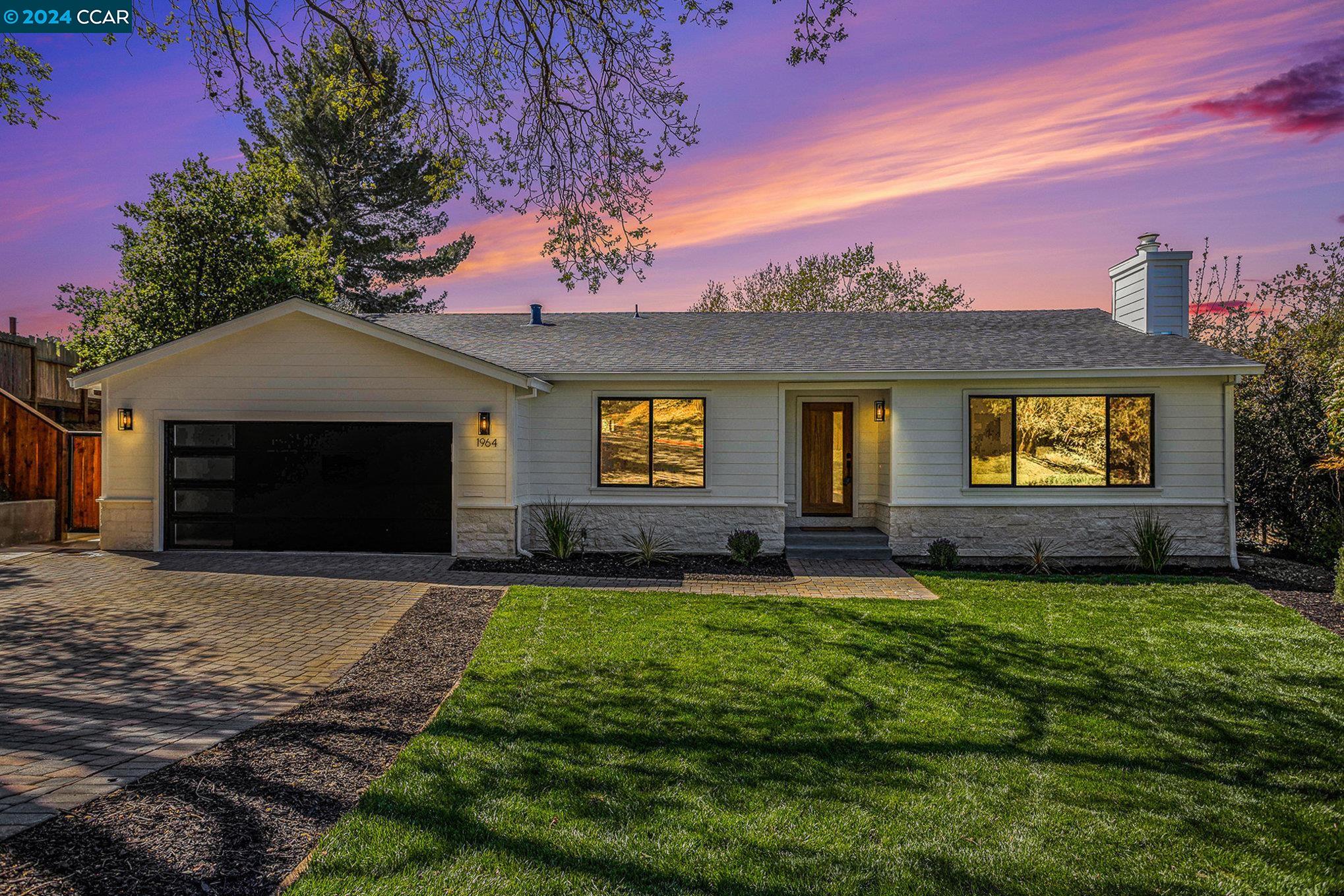 a view of a house with a yard and a fireplace