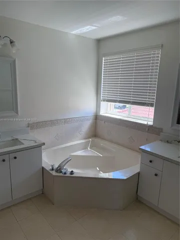 a bathroom with a shower and a sink