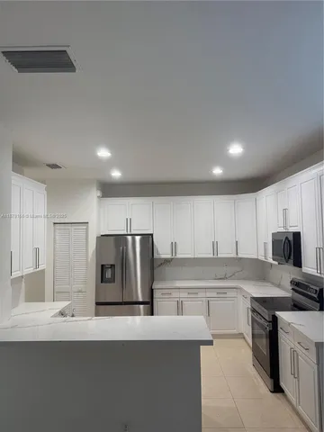 a kitchen with a sink cabinets and stainless steel appliances