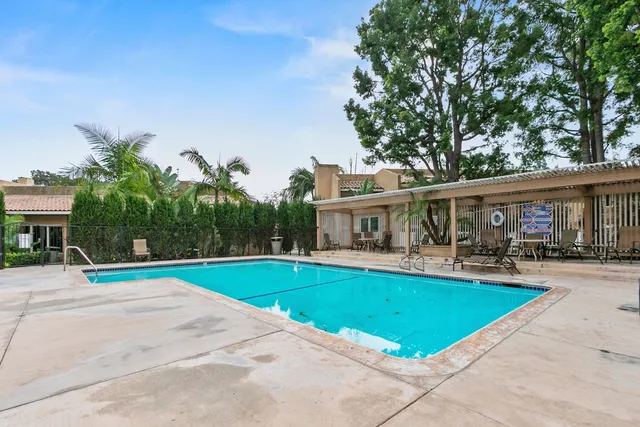 a view of a house with swimming pool and a yard