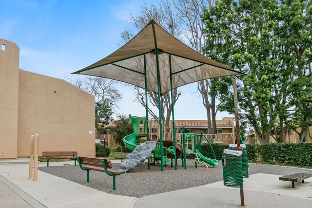 a view of backyard with outdoor seating and plants