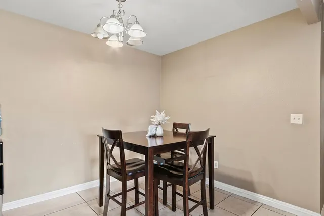 a view of a dining room with furniture and chandelier