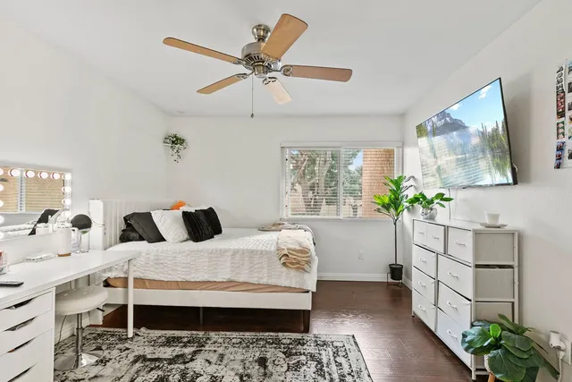 a bedroom with a bed and a potted plant