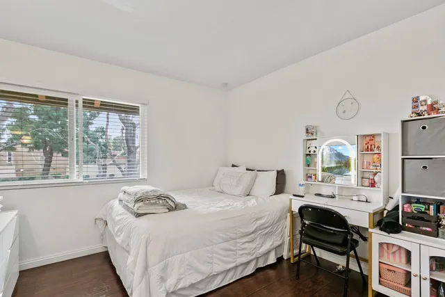 a bedroom with a bed and a large window