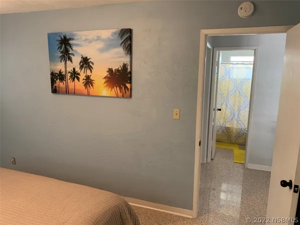 a view of a hallway with wooden floor and closet area