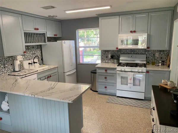 a kitchen with a stove and a microwave