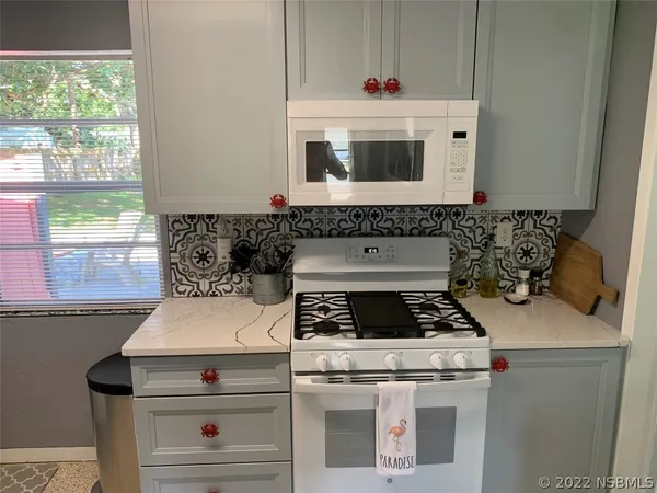 a kitchen that has a sink and a stove in it