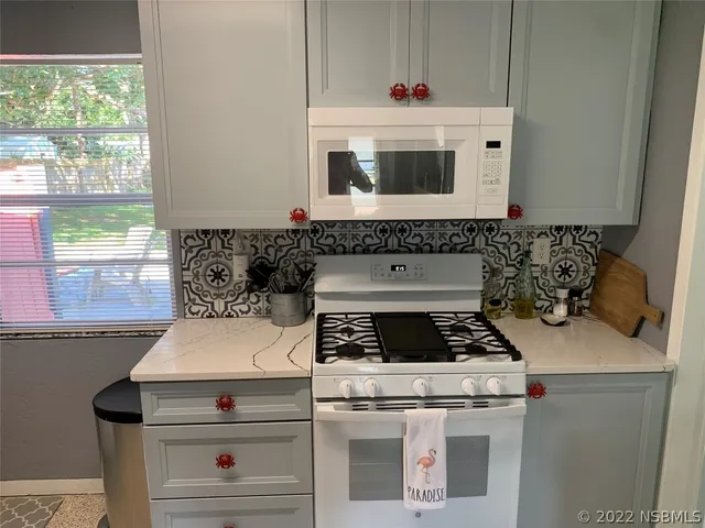 a kitchen that has a sink and a stove in it