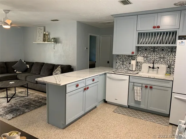 a bed sitting in a bedroom next to a window with wooden floor