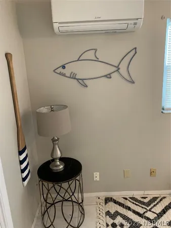 a view of a dining room with furniture a chandelier and wooden floor