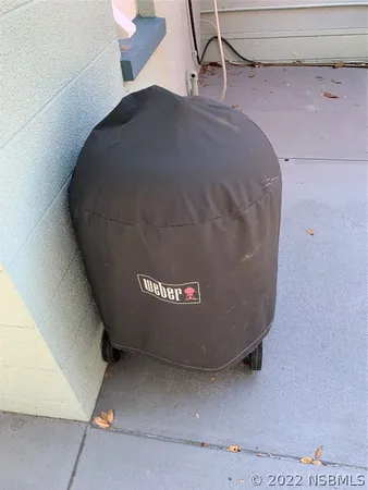a white wall with two painting on the wall and a window