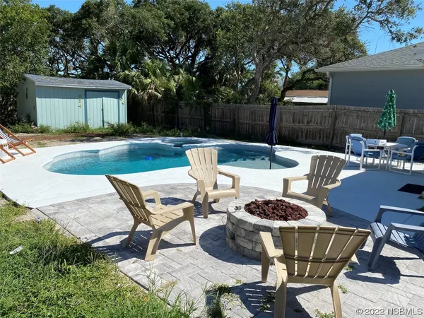 a view of a house with backyard sitting area and garden