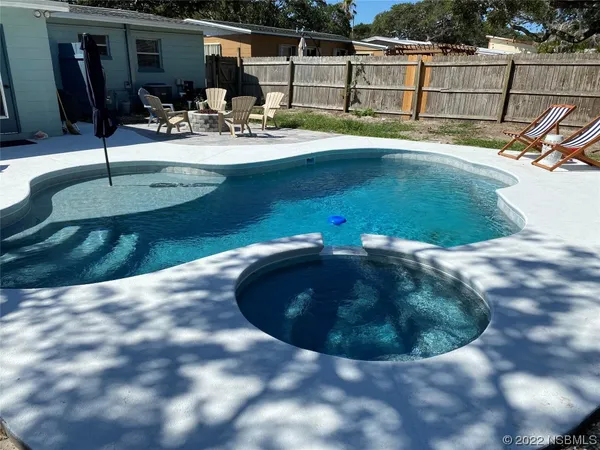 a view of a backyard with couches table and chairs