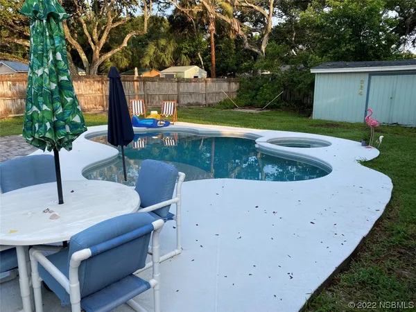 a patio with couch and chairs