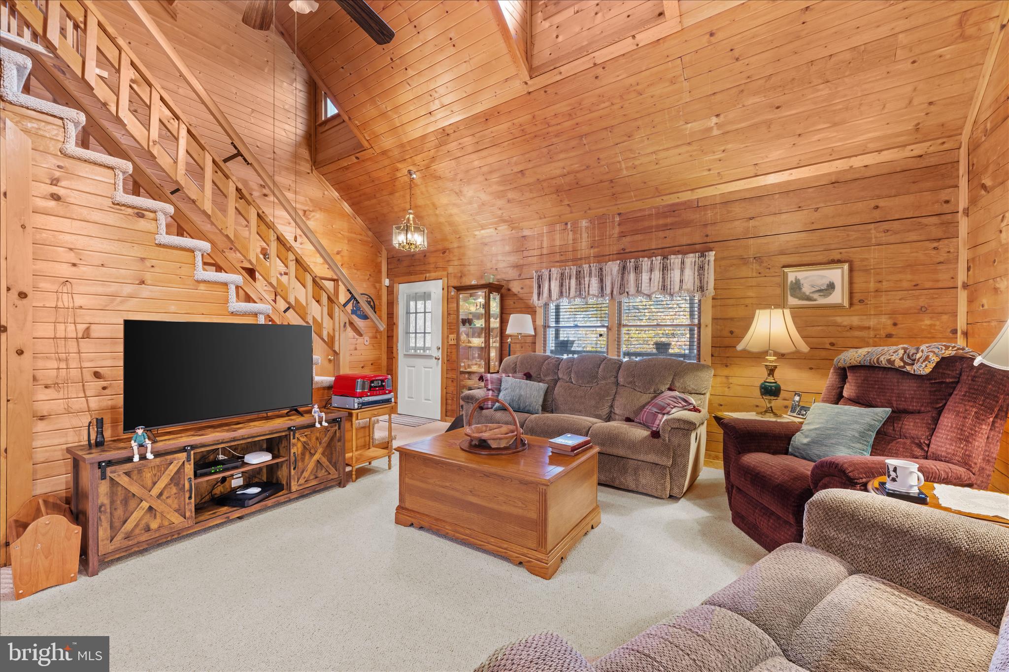 4176 Timber Ridge Road Berkeley Springs, WV 25411 - Photo 14 of 61 a living room with furniture and a flat screen tv