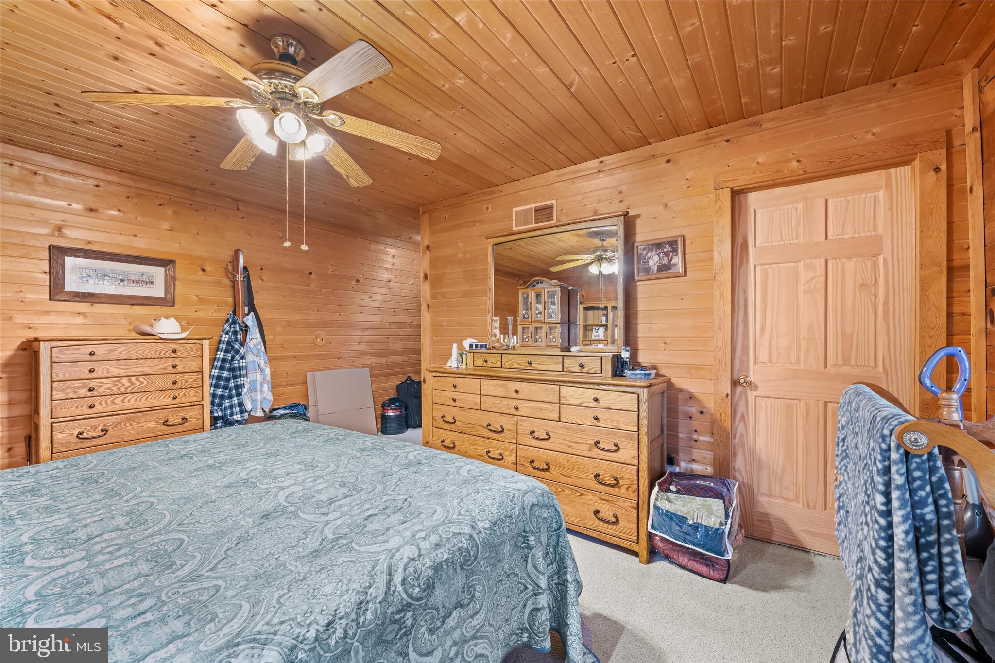 4176 Timber Ridge Road Berkeley Springs, WV 25411 - Photo 18 of 61 a bedroom with a bed and a chandelier