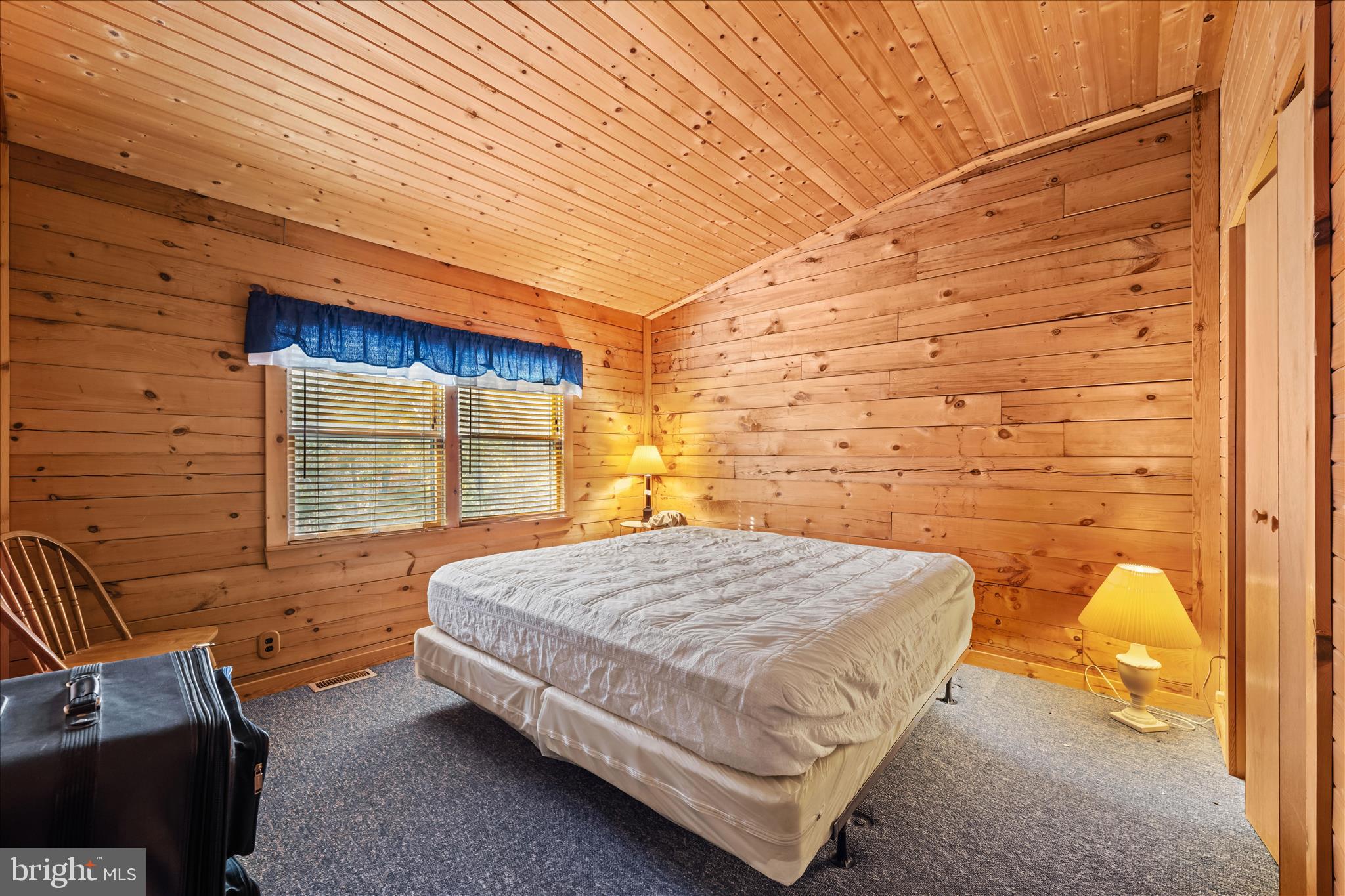 4176 Timber Ridge Road Berkeley Springs, WV 25411 - Photo 27 of 61 a bedroom with a bed and wooden floor
